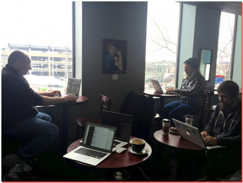 Three guys working at coffee shop